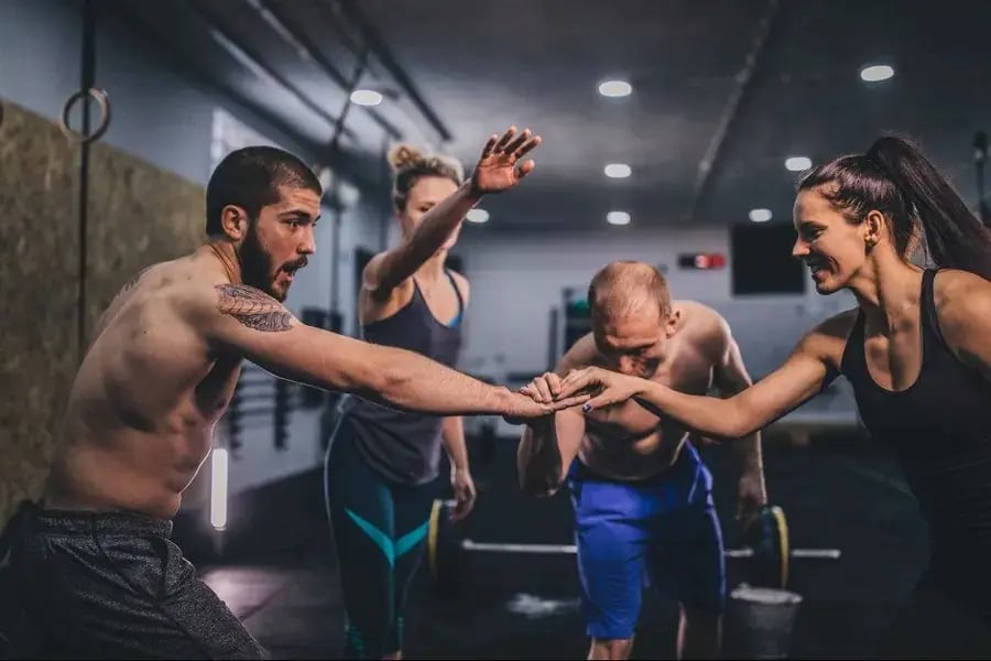 Athletes celebrating together in a gym