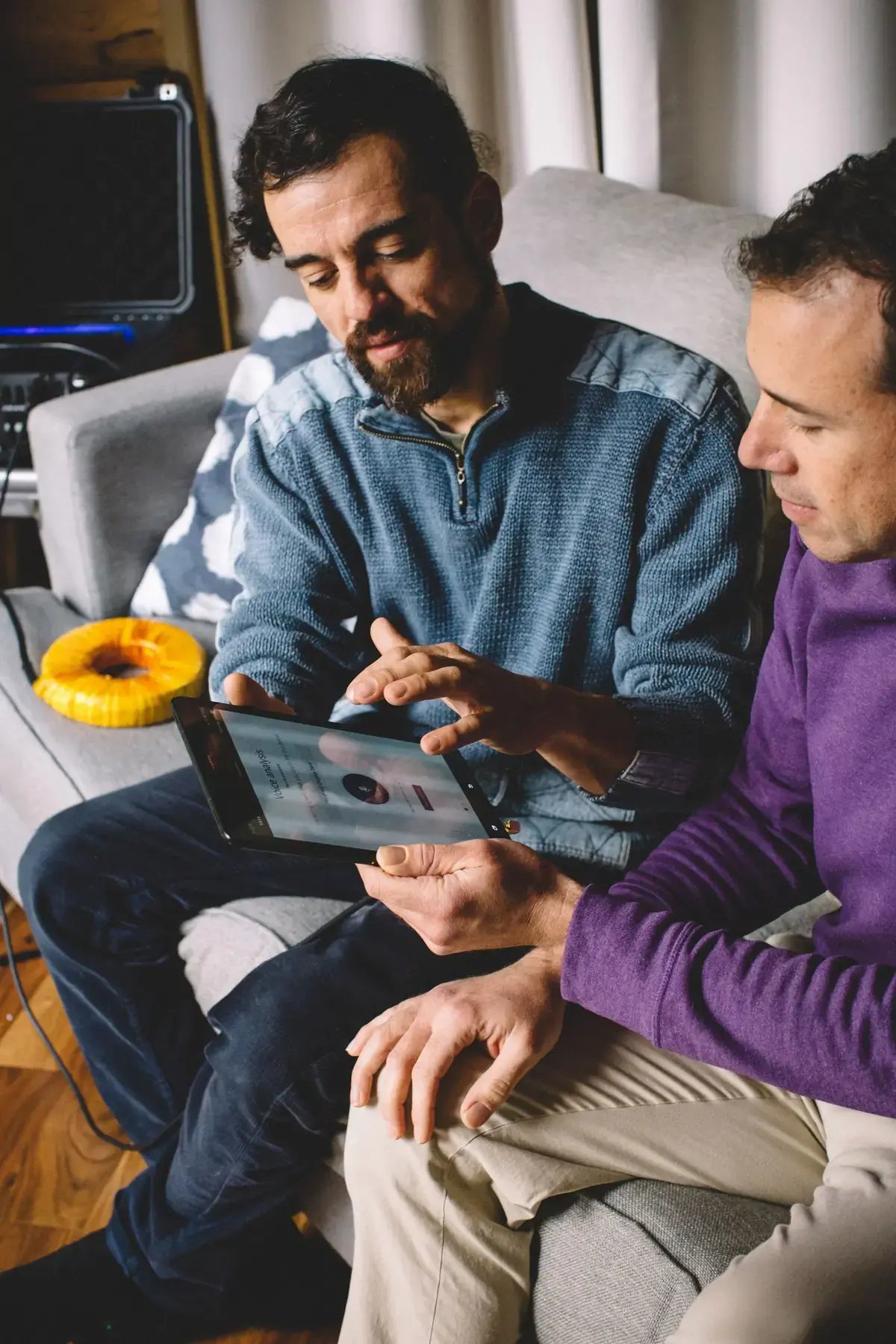 Practitioner showing a client the BetterGuide app during an AmpCoil session