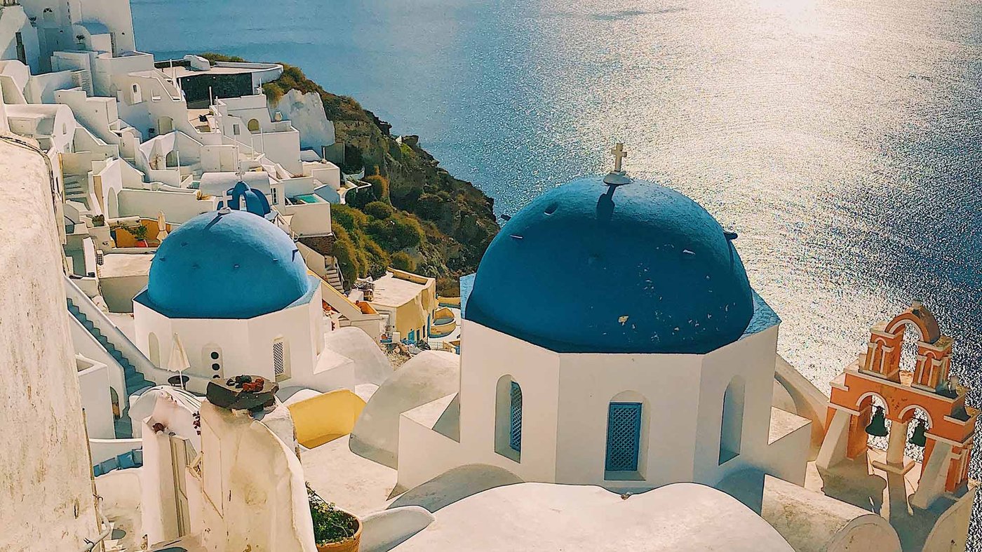 Blue-domed churches above the sea in Santorini, Greece