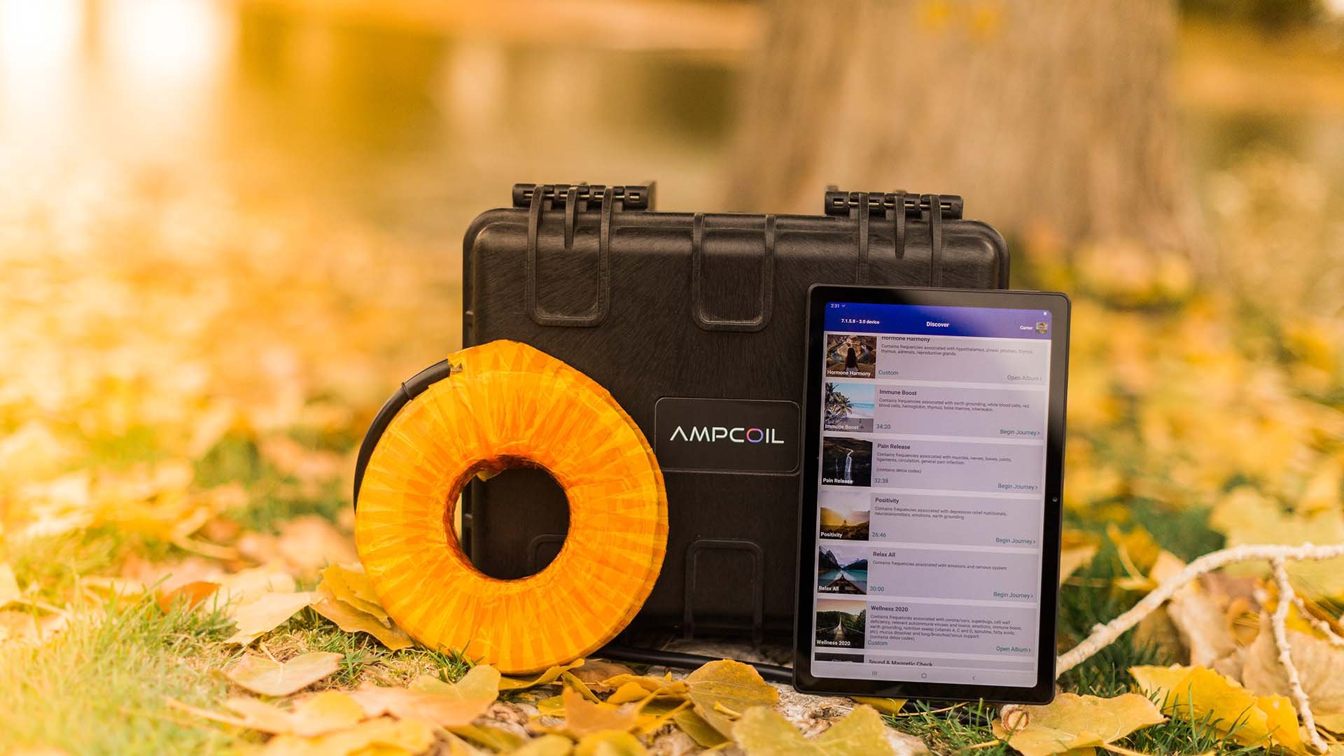 AmpCoil case, coil and tablet outdoors among autumn leaves