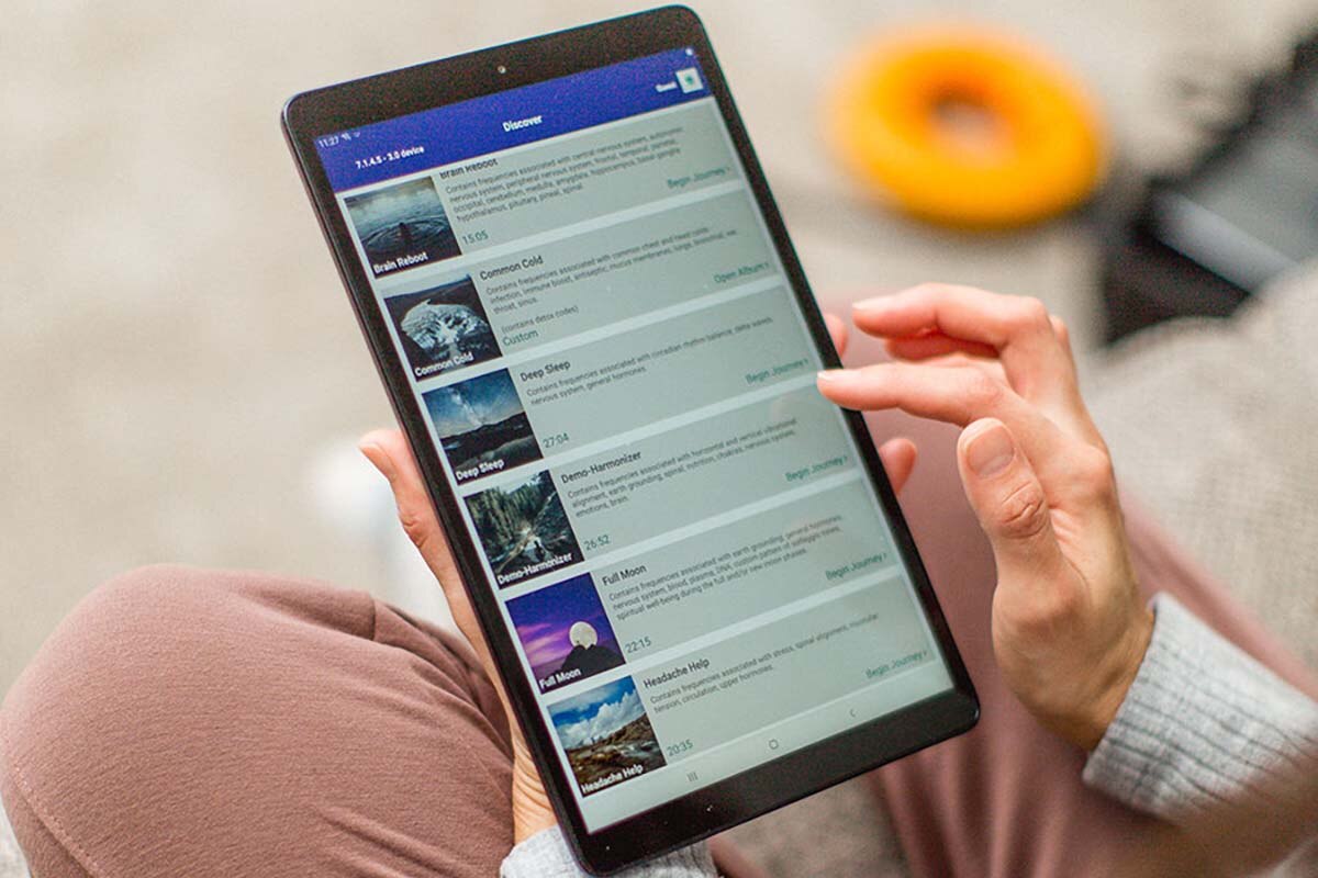 Person using AmpCoil Better Guide App on a tablet