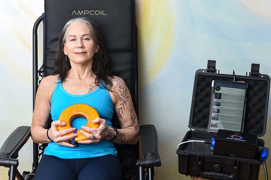 woman using AmpCoil PEMF System with mat woman using AmpCoil PEMF System with mat